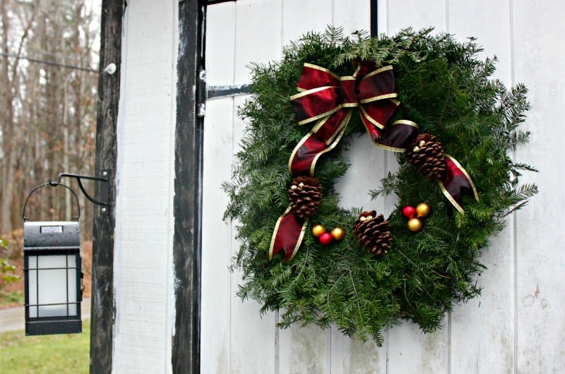 a Christmas wreath hanging on a white door