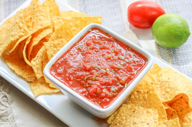 homemade salsa with chips in a white bowl