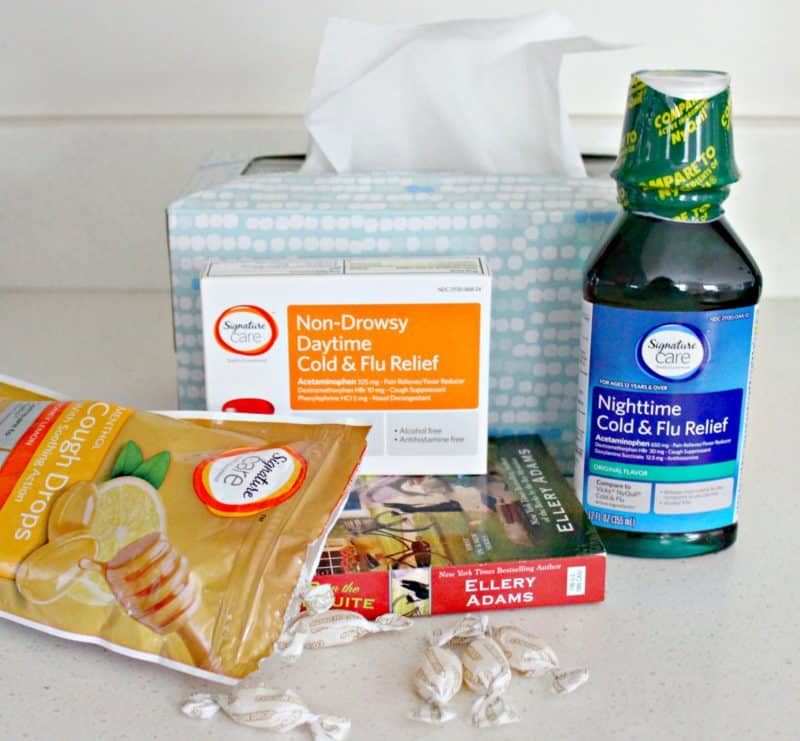 cough and cold products with a book on a table