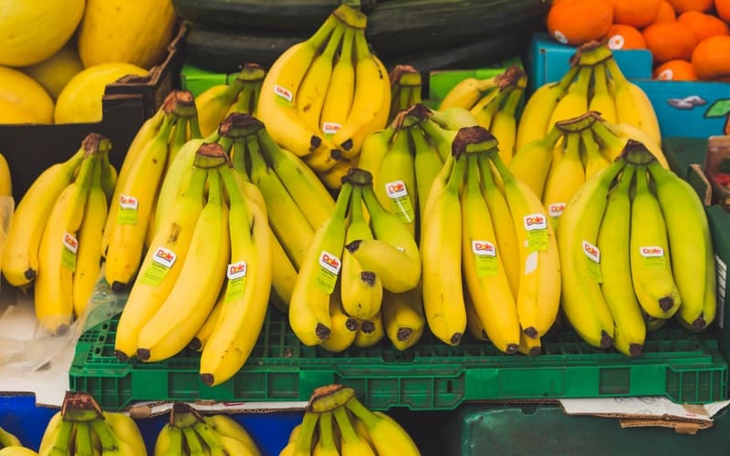 a row of bananas for sale at the grocery store