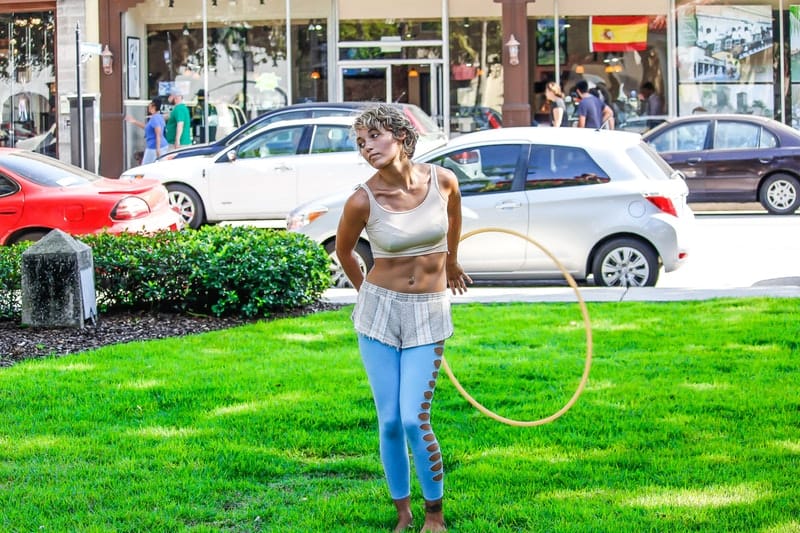 Woman doing the hula hoop outside