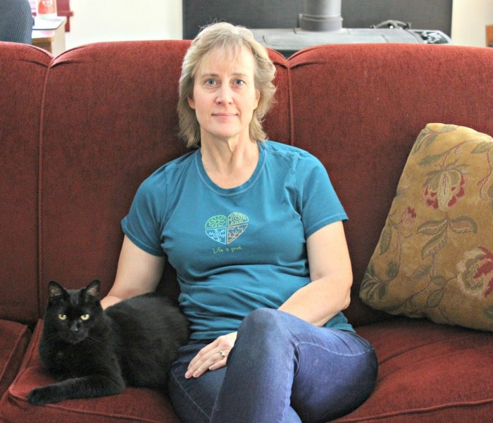 woman with black cat on couch