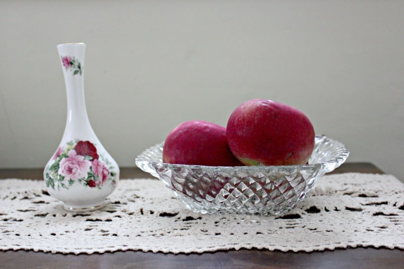 a crystal bowl with apples