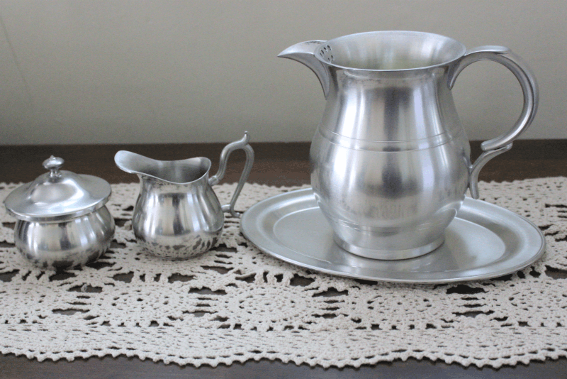 pewter pitcher and tray on a buffet