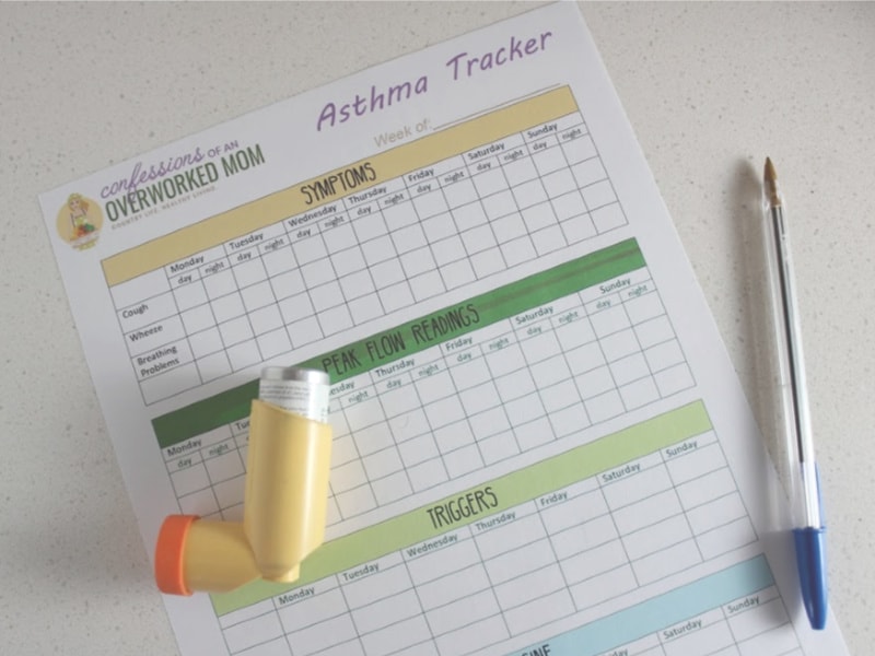 asthma inhaler, tracking sheet and a pen