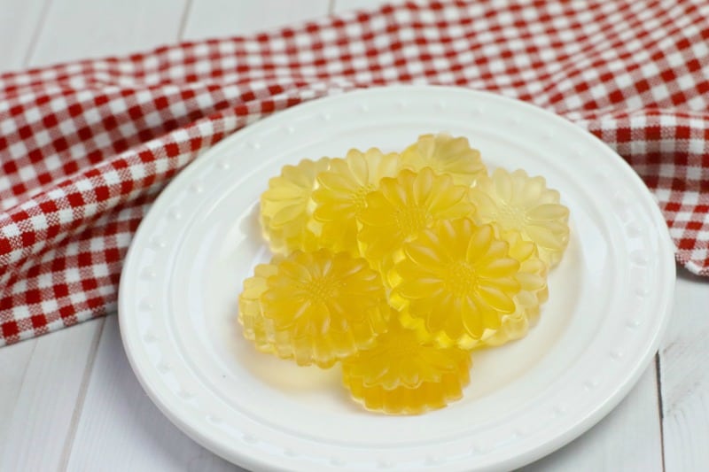 ACV gummies on a white plate near a red and white cloth