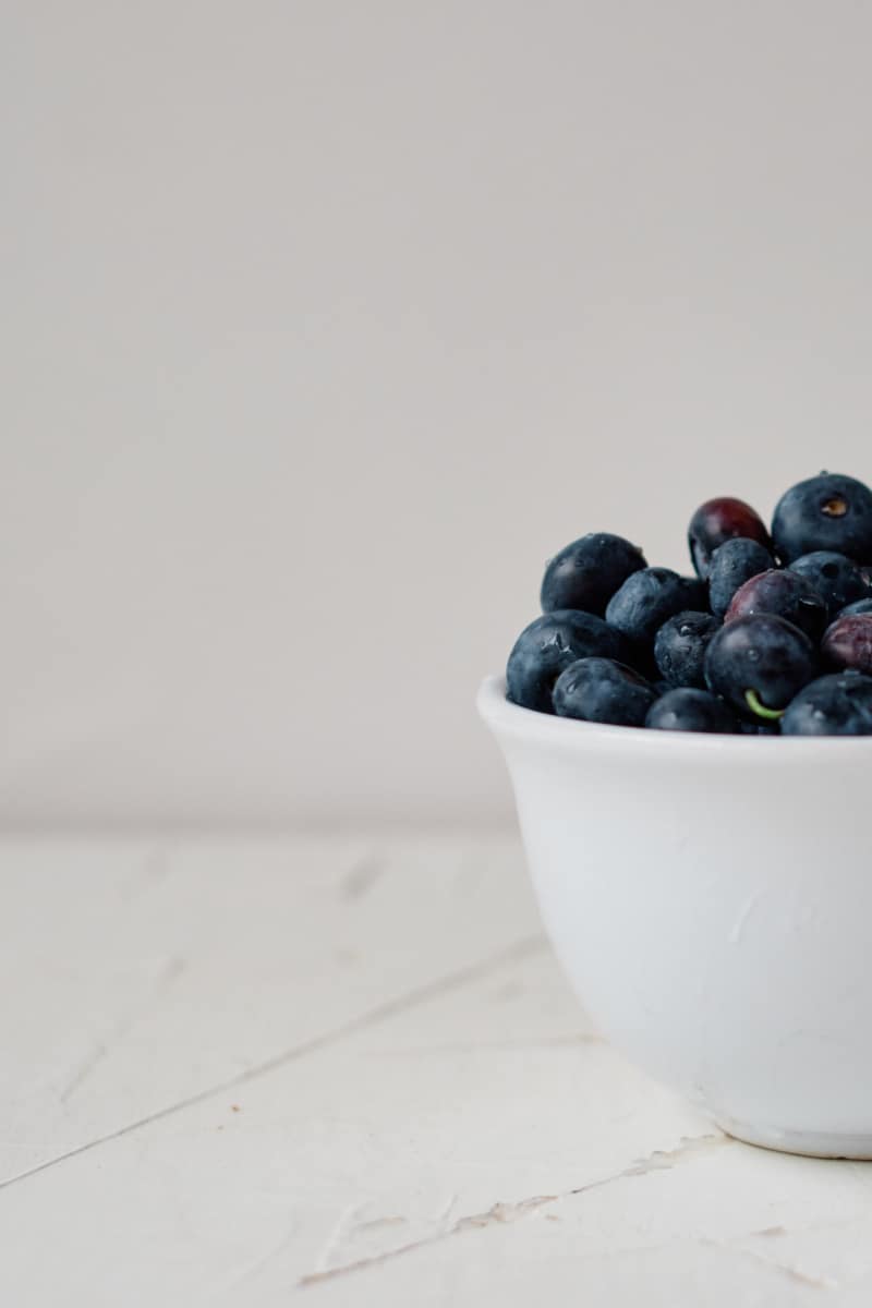 a white bowl full of fresh berries