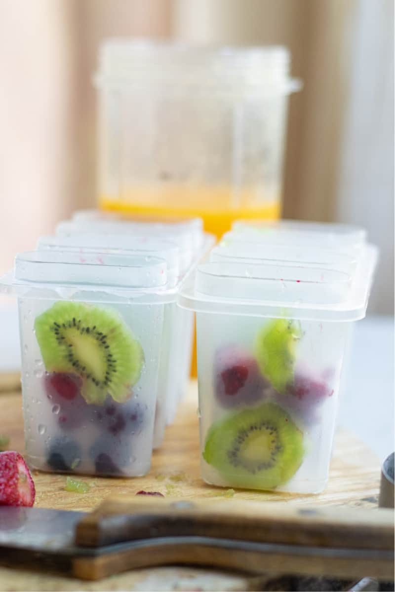 popsicle containers with fruit in them