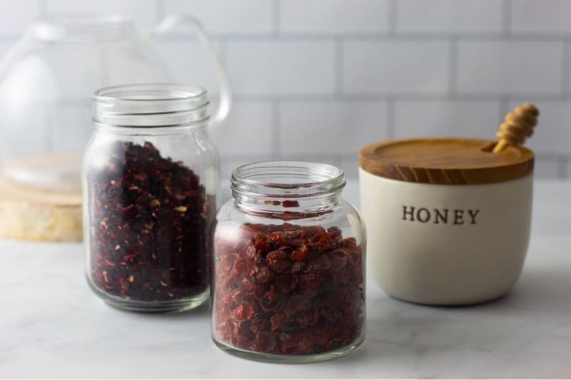 dried rosehips and hibiscus in glass jars