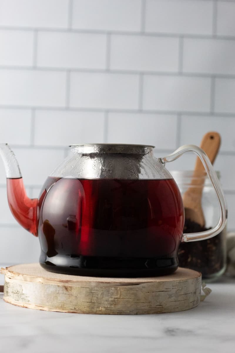 a glass tea pot with rosehip and hibiscus tea