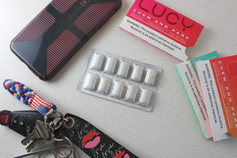 a pack of Lucy's Chew and Park gum, keys, and a phone on the counter