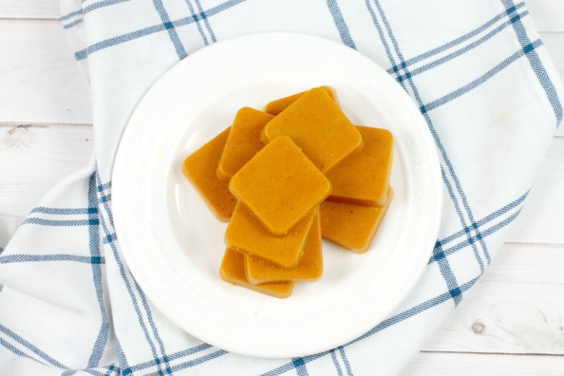 a white plate with turmeric candy on it