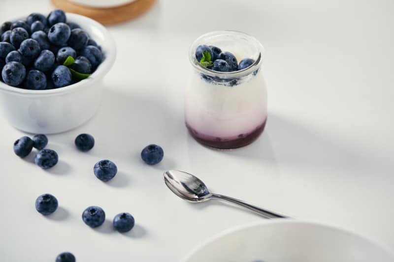 a cup of yogurt with blueberries