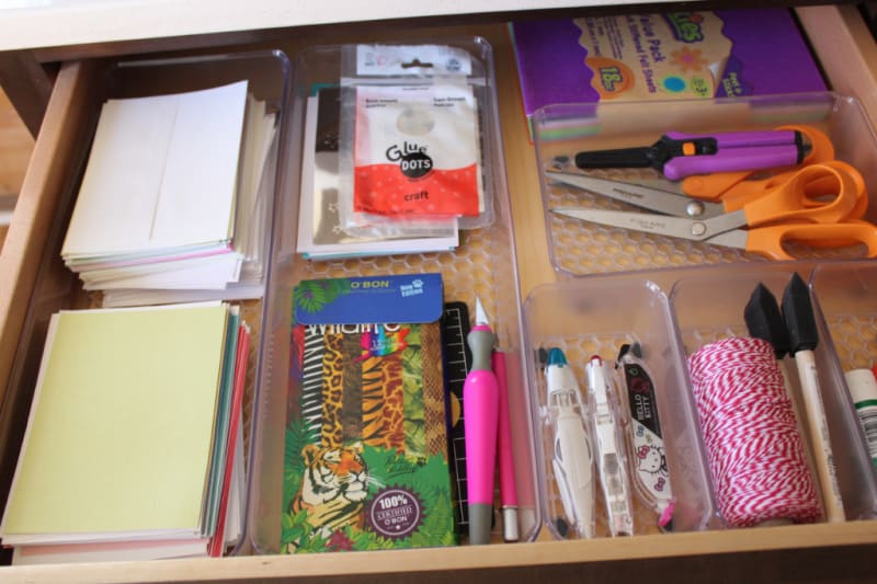 an organized drawer full of art supplies