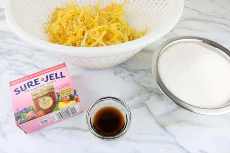 ingredients to make jelly on a white counter