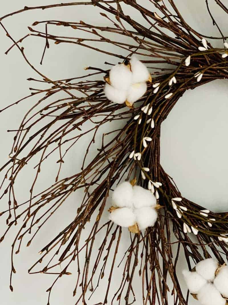 Check out this cotton wreath DIY. If you're looking for a cute summer wreath idea, why not make this farmhouse cotton wreath for your door?