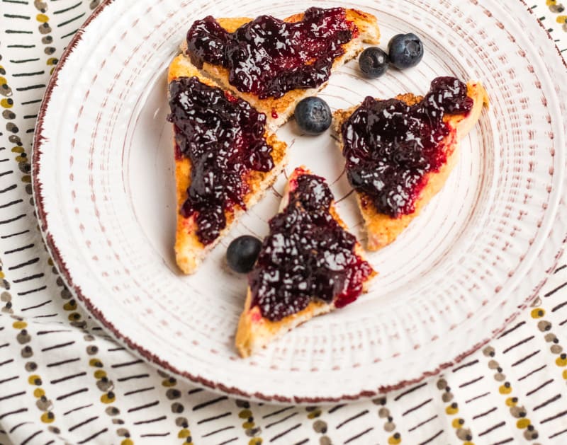 blueberry jam on toast on a white dish