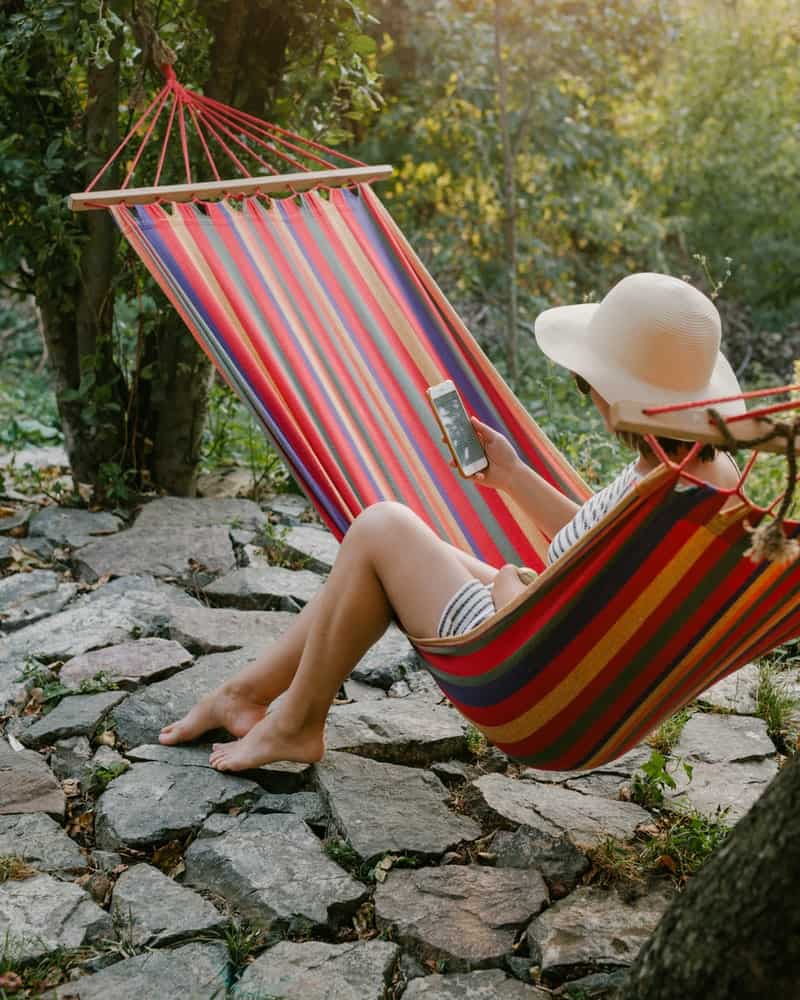 a woman relaxing in a red hammock