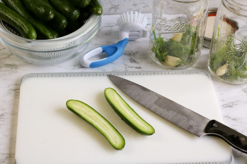 cucumbers and a knife on a cutting board