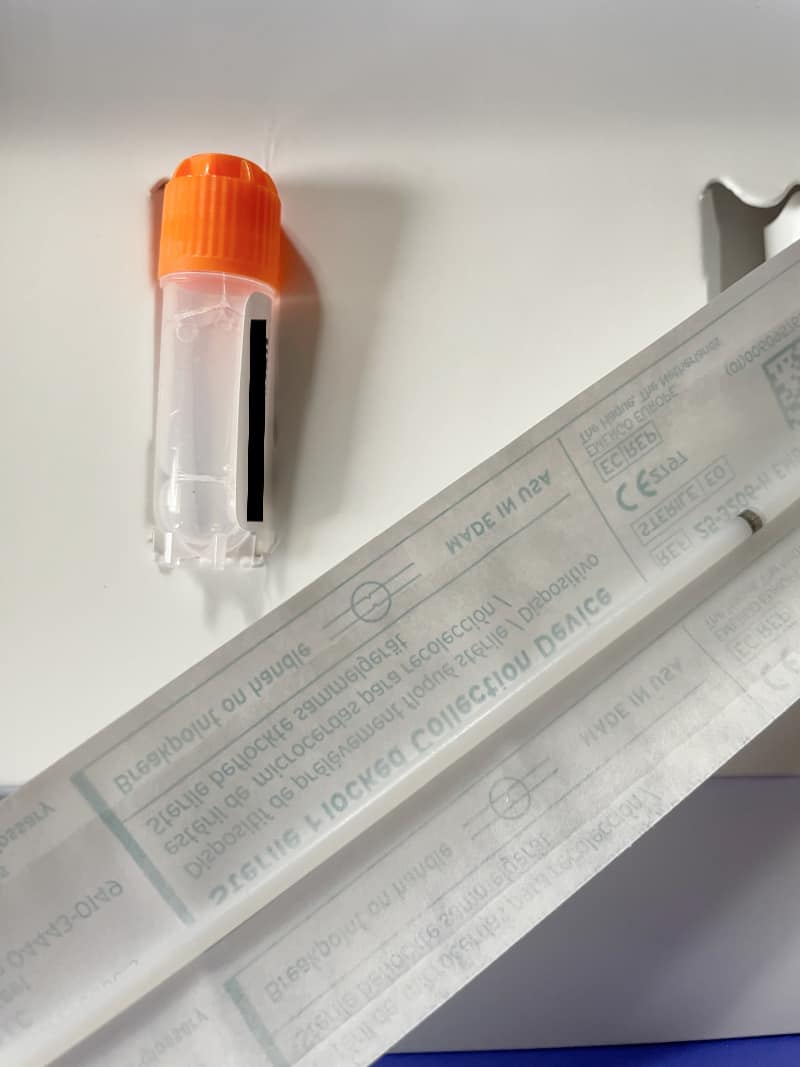 a kit containing a vial and a swab