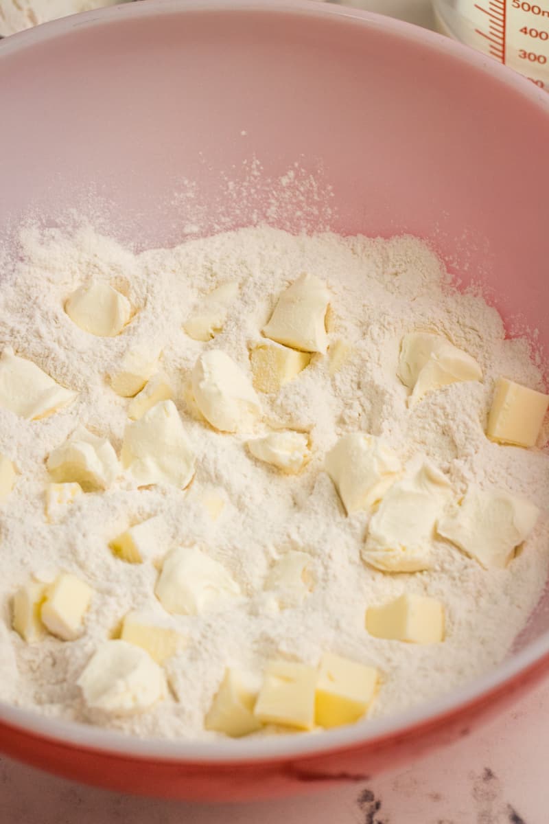 flour and butter in a red bowl