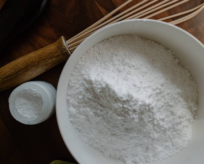 powdered sugar in a bowl near a whisk
