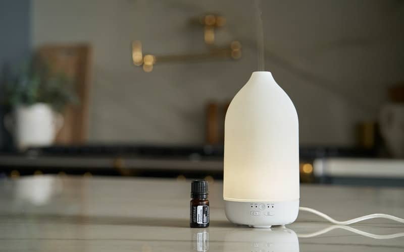 a diffuser on the counter in a dark room