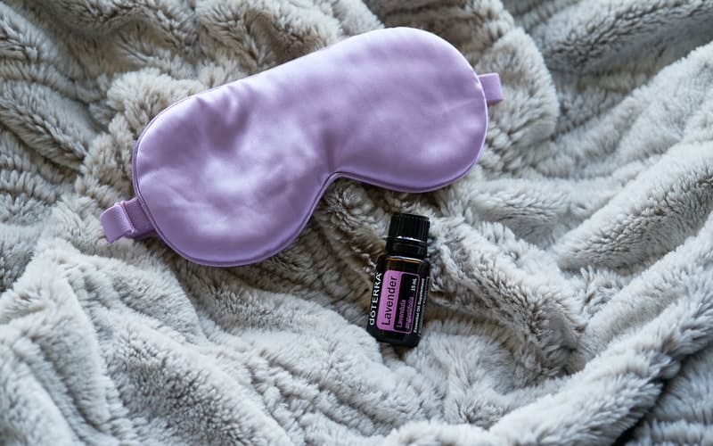 a purple sleep mask on a blanket