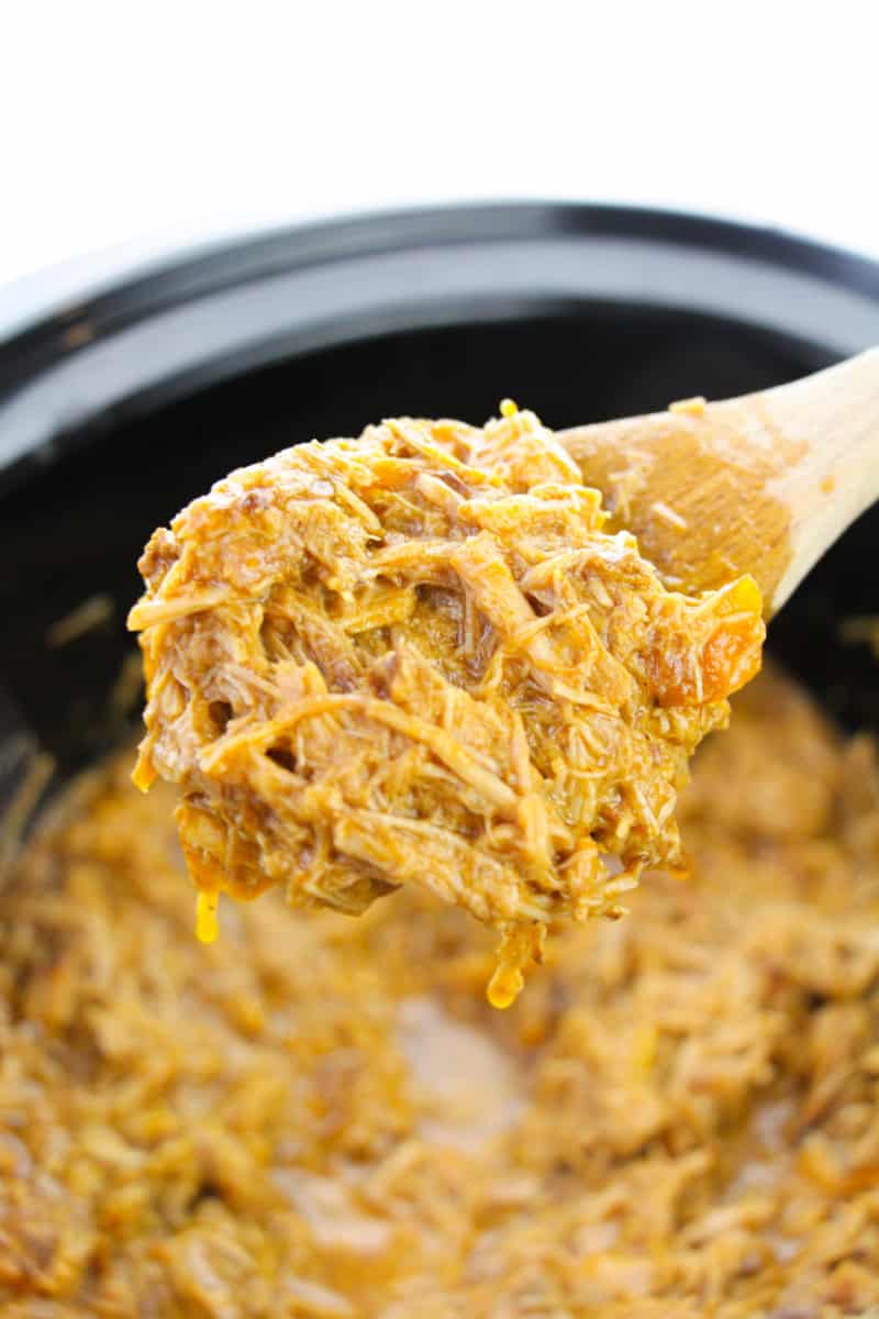 spooning pulled pork from a slow cooker