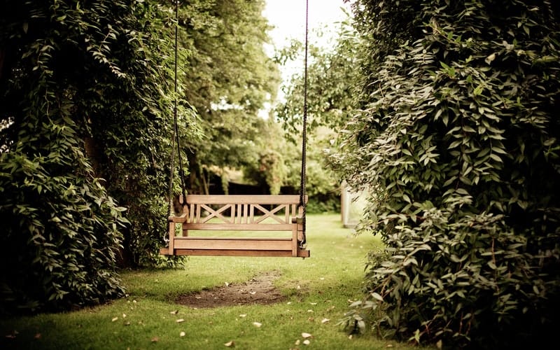 a wooden garden swing