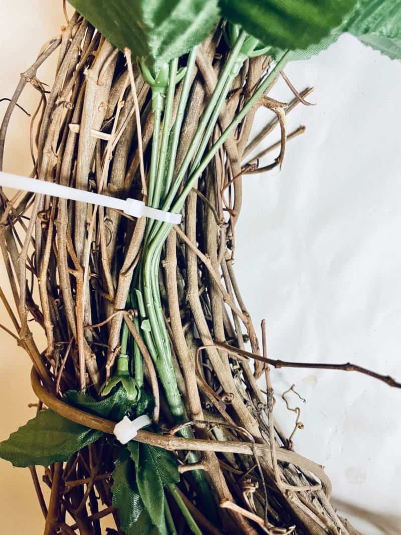 a zip tie holding stems to a wreath