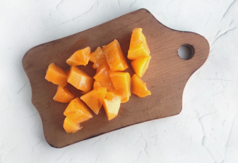 chunks of persimmon on a cutting board