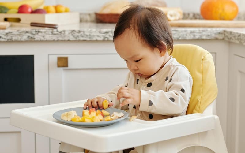 a child in a highchair eating