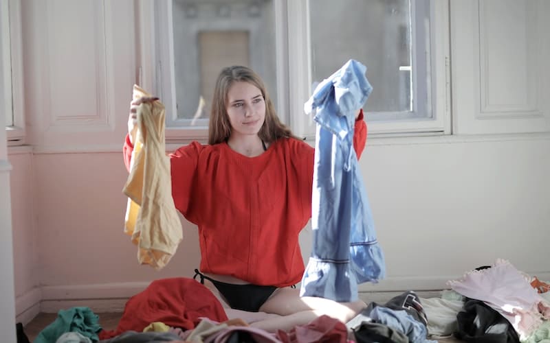 a woman decluttering clothes