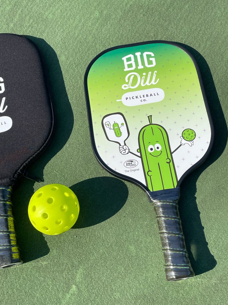 pickleball paddle and ball on the court