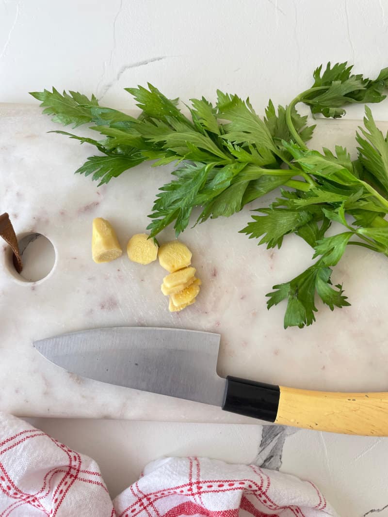 ginger and herbs on a cutting board