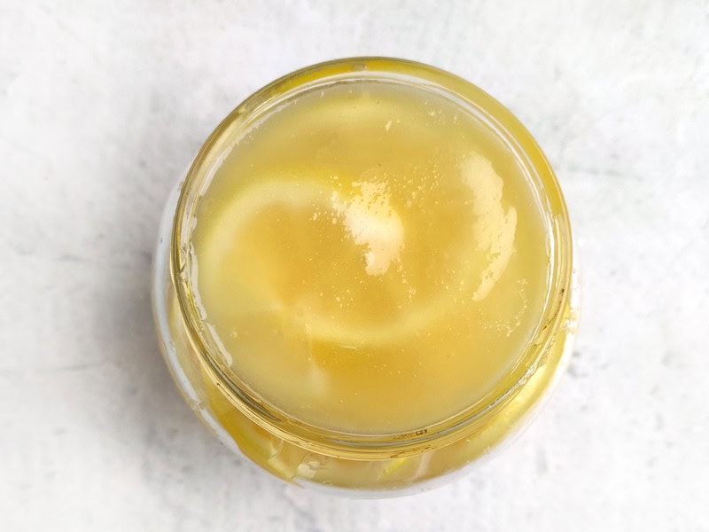 lemons preserved in honey in a glass jar