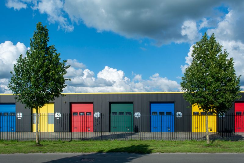 commercial building with colorful garage doors