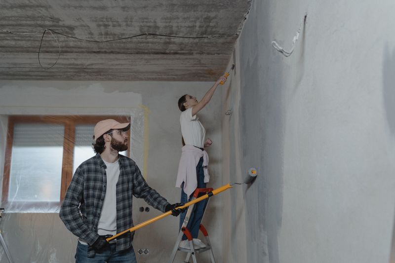 couple painting a room