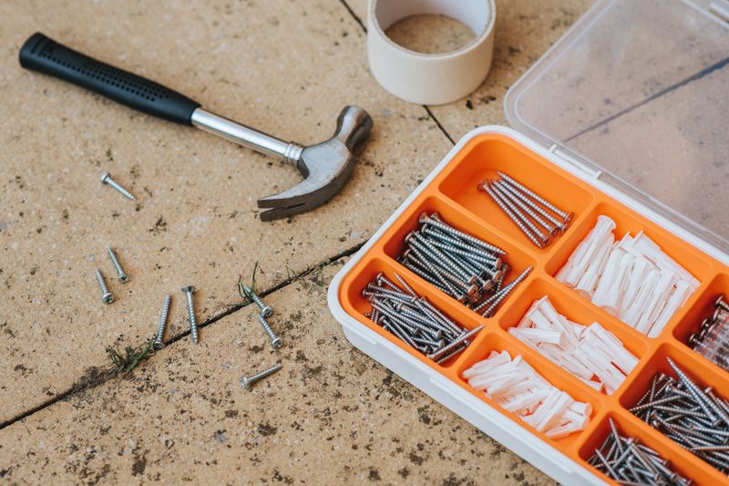 repair tools near screws in a box