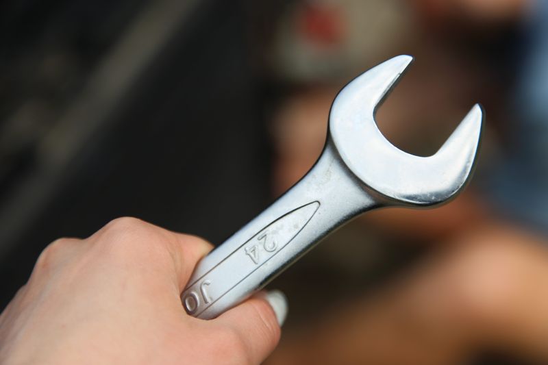 hand holding a wrench