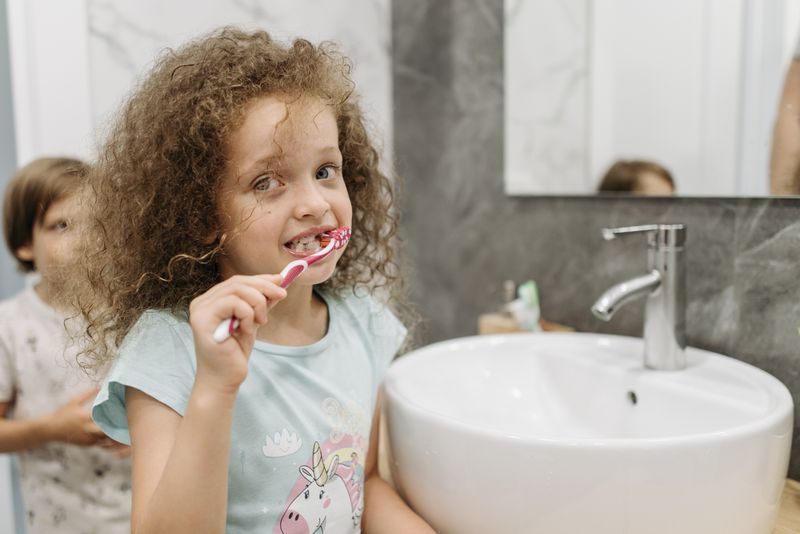 child brushing their teeth