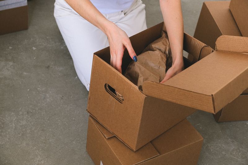 woman packing belongings in boxes